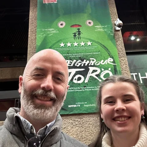 Ben and his daughter smiling outside a stage production of My Neighbour Totoro
