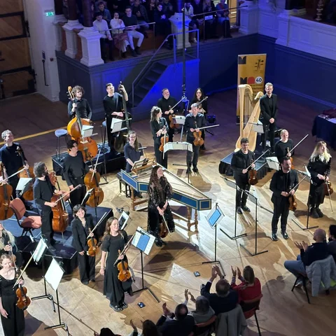 An orchestra performing in a concert hall