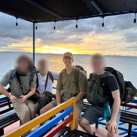 Ben’s son and three friends at sunset beside a lake